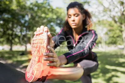 Highlighted ankle of stretching woman