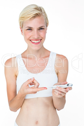 Attractive blonde woman doing test with blood glucose monitor