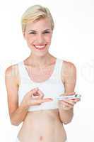 Attractive blonde woman doing test with blood glucose monitor