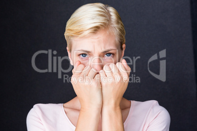 Anxious blonde woman looking at camera
