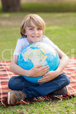 Little boy holding a globe