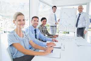 Business team during meeting smiling at camera