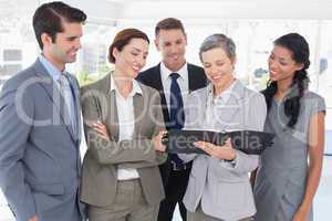 Business people looking together in the notebook