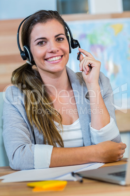 Pretty travel agent smiling at camera