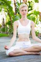 Pretty fit blonde woman meditating