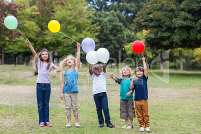 Happy children holding balloons