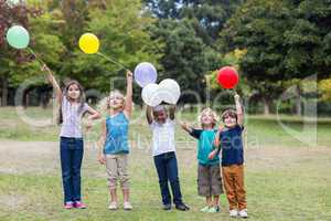 Happy children holding balloons