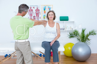 Doctor stretching his patients arm