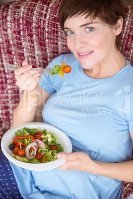 Pregnant woman eating a salad