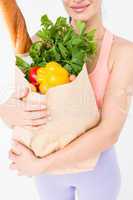 Slim woman holding bag with healthy food