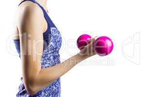 Fit woman lifting pink dumbbell