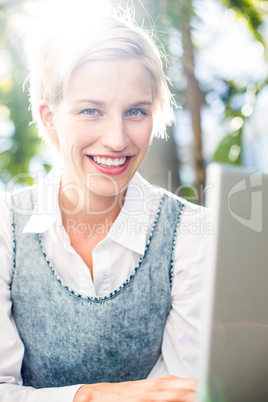 Pretty blonde woman using her laptop