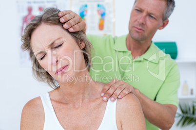 Doctor doing neck adjustment