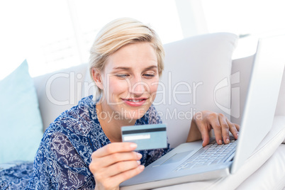 Pretty blonde woman doing online shopping