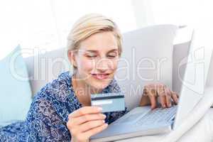 Pretty blonde woman doing online shopping