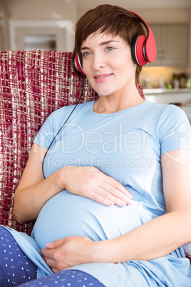 Pregnant woman listening to music