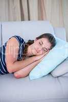 Peaceful woman sleeping on couch