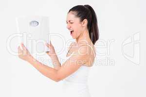 Fit woman holding weighing scales