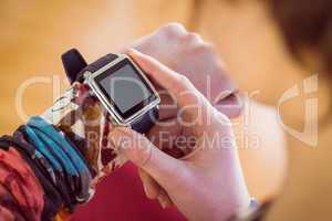 Slim woman using her smartwatch