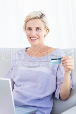 Pretty blonde woman doing online shopping