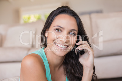 Pretty brunette calling with her mobile phone