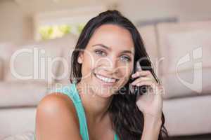 Pretty brunette calling with her mobile phone