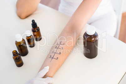 Doctor doing skin prick test at her patient