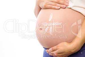 Pregnant woman with cream on bump