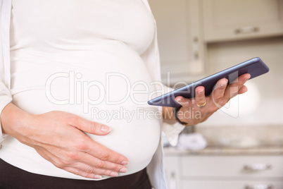 Pregnant woman using tablet pc