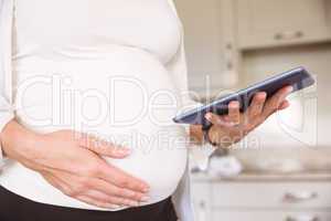 Pregnant woman using tablet pc