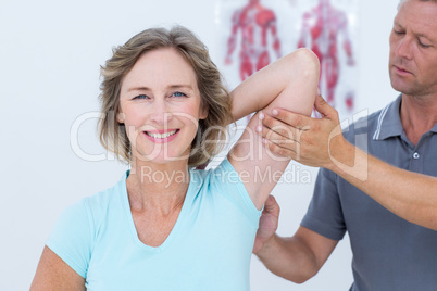 Woman stretching her arms with her doctor