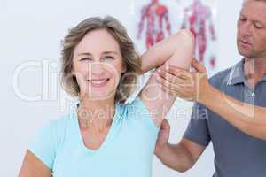 Woman stretching her arms with her doctor