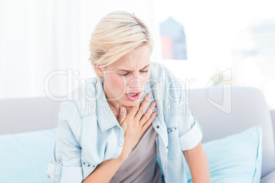 Pretty blonde woman having breath difficulties
