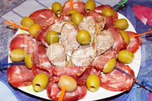 meat cutting into pieces and olives