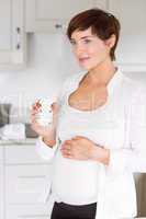 Pregnant woman having a hot drink