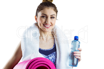 Fit brunette holding yoga mat