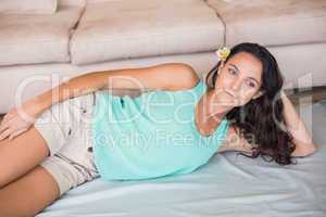 Pretty brunette lying on the floor