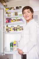 Pregnant woman opening the fridge
