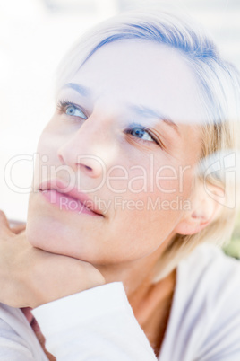 Smiling blonde woman looking through the window