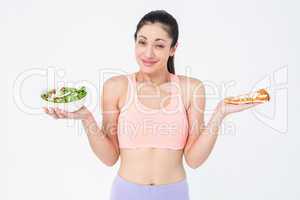 Pretty brunette holding pizza and salad
