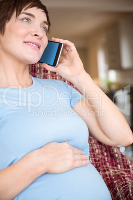 Pregnant woman making a call