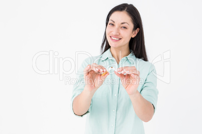Smiling woman snapping cigarette in half
