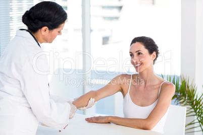 Doctor looking at her patients arm