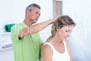 Doctor doing neck adjustment