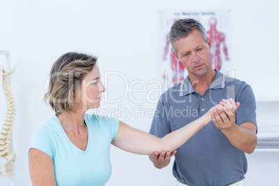 Doctor stretching his patients arm