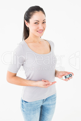 Diabetic brunette holding blood glucose monitor