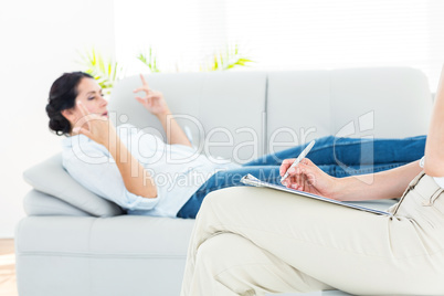 Therapist listening her patient and taking notes