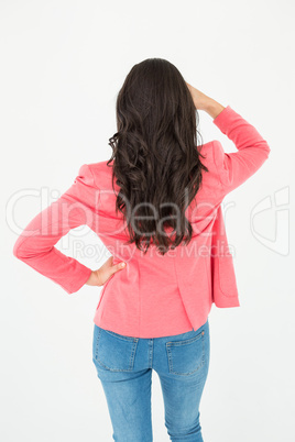 Elegant brunette standing back to camera and looking away