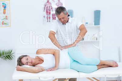 Doctor massaging his patient hip