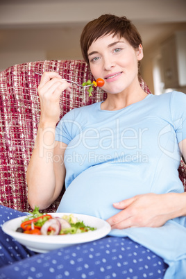 Pregnant woman eating a salad